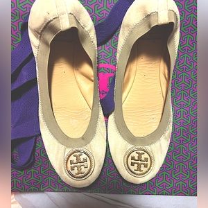 Tory Burch tan with gold hardware with shopping bag.